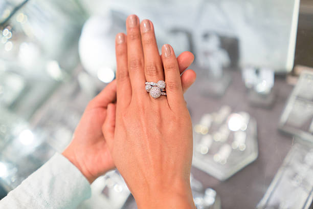 istock Woman trying an engagement ring at the store 588611034