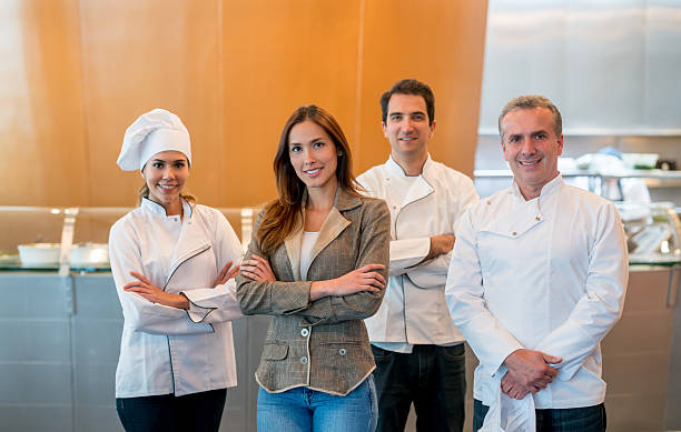 istock Business owner at a restaurant with her staff 588611060
