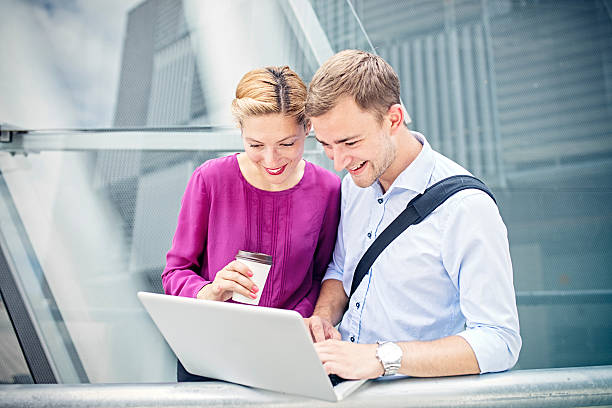 istock Two business people meeting outside modern building 588611206