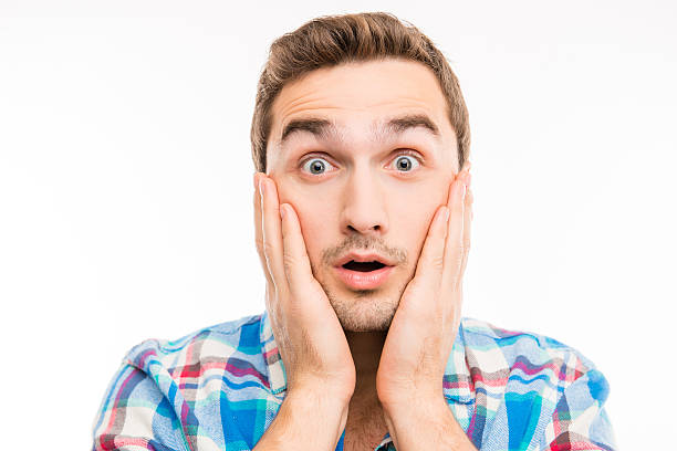 istock Closeup photo of a surprised handsome young man 588611220