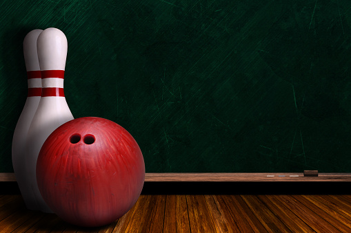 Bowling ball and pins on a background chalk board with copy space.