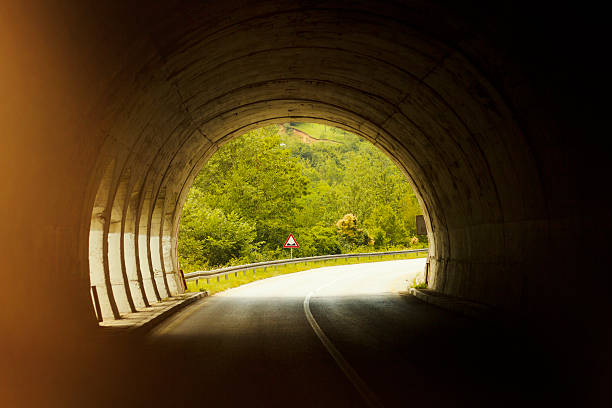 istock Road with tunnel and sunlight 588612500