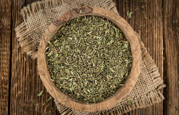 istock Old wooden table with dried Stevia leaves (selective focus) 588613362