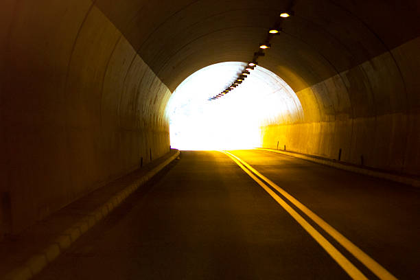 carretera con túnel y luz solar - copy space road sign sky above fotografías e imágenes de stock