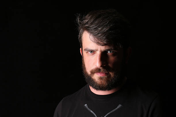 istock Bearded man in T-shirt with serious look. Close.up 588614174