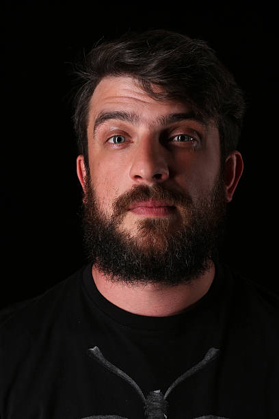istock Portrait of bearded guy with interesting look. Close.up. Black 588614390