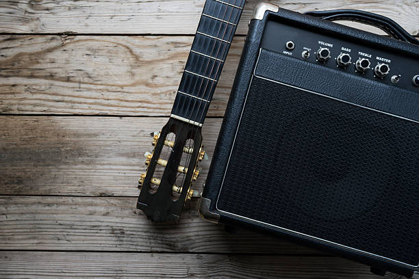 istock Guitar amplifier and guitar on wood table 588614830