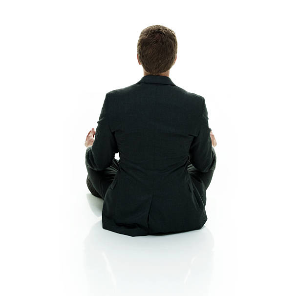 istock Rear view of businessman doing meditation 588615216
