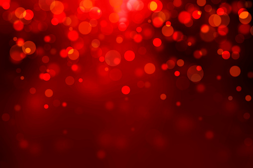 Christmas lights bokeh on dark red background. This file is cleaned and retouched.