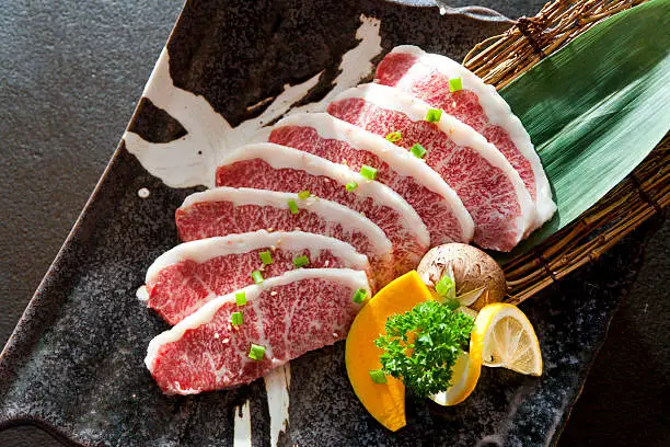 Wagyu Beef sliced decorated in a plate on table