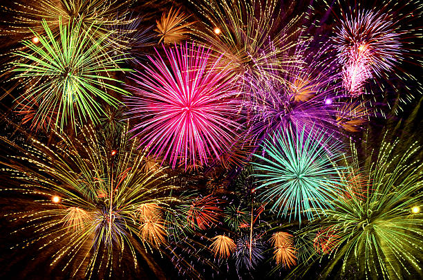 istock Beautiful fireworks show on clear night sky. 588621624