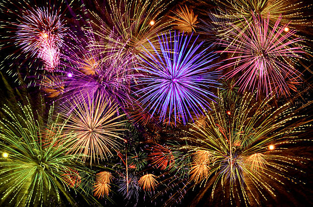 istock Beautiful fireworks show on clear night sky. 588621800
