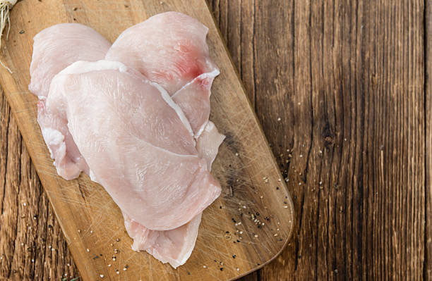 istock Old wooden table with raw Chicken Cutlet 588623318