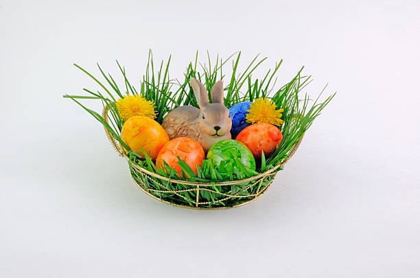 istock Easter basket with bunny and eggs in the grass 588623528