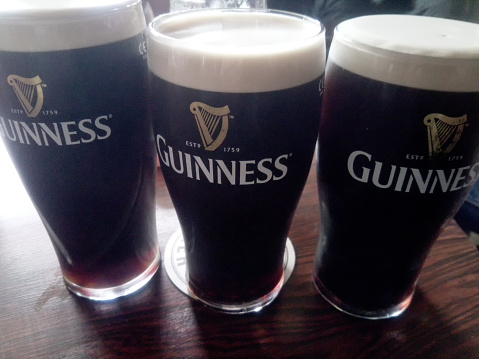 Wexford, Ireland - June 18, 2016: Three pints of british stout in Guiness glasses