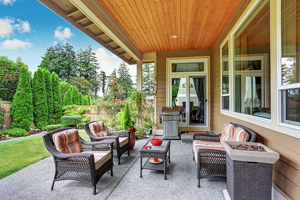 istock Cozy covered sitting area with wicker chairs and barbecue 588625464