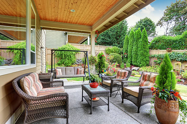 istock Cozy covered sitting area with wicker chairs and swing 588625528
