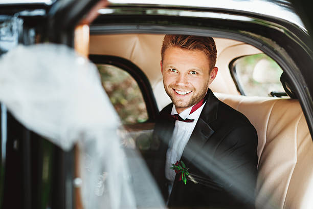 istock Bridegroom sitting in wedding car 588954206