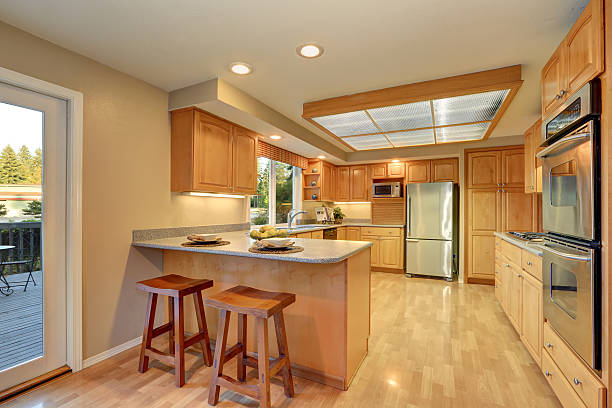 istock Bright wooden kitchen interior with steel appliances. 588954218