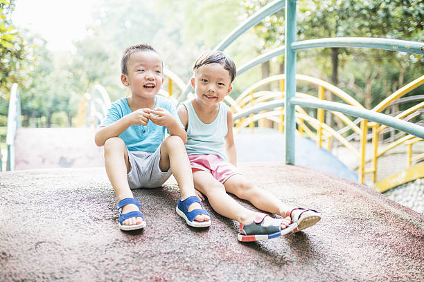 istock Cute children playing in the park 588954508