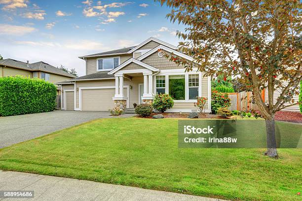 Neat Beige Home With Two Garage Spaces Stock Photo - Download Image Now - House, Springtime, Outdoors