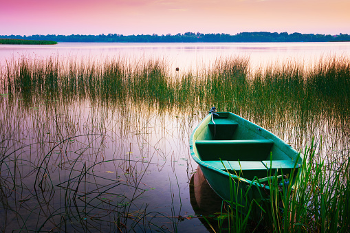 Rowing boat floating over the Lake Lasmiady  waters. Masuria, Poland.