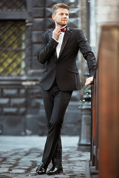 istock Bridegroom in suit standing outdoor 588956144