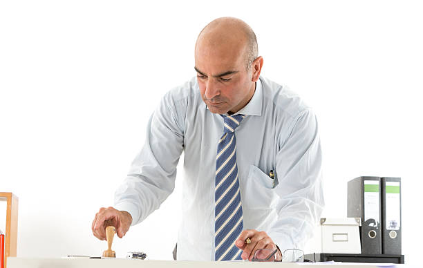istock Fascinating office worker in office stamping paperwork 588957436