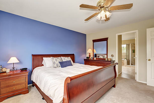 istock Simple yet cozy bedroom with contrast lavender wall 588957658