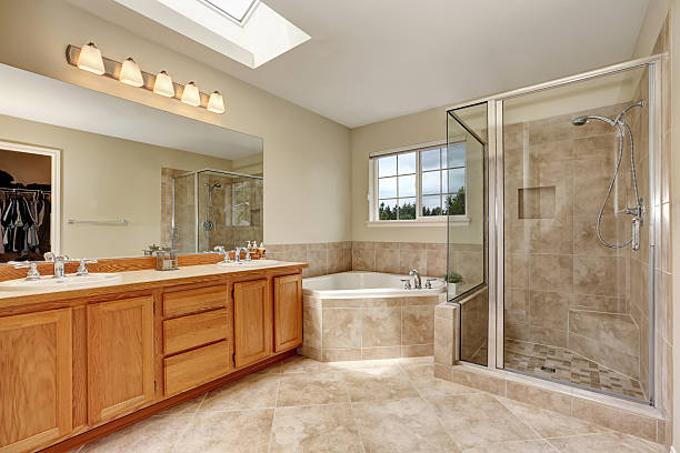 istock Master bathroom with corner bathtub and tile floor 588957744