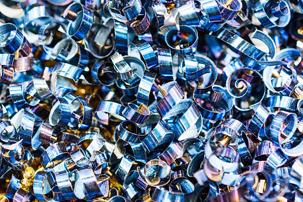 Aluminum shavings collected from an industrial milling machine for recycling. Great industrial texture for a background or other graphic element. Canon 5DII, 1 off-camera flash.
