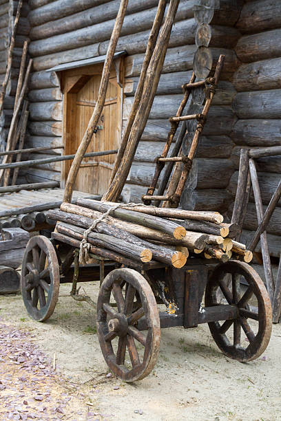 istock Old wooden cart with attached logs on it 588959266