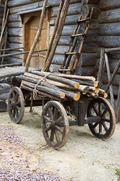 istock Old wooden cart with attached logs on it 588959278