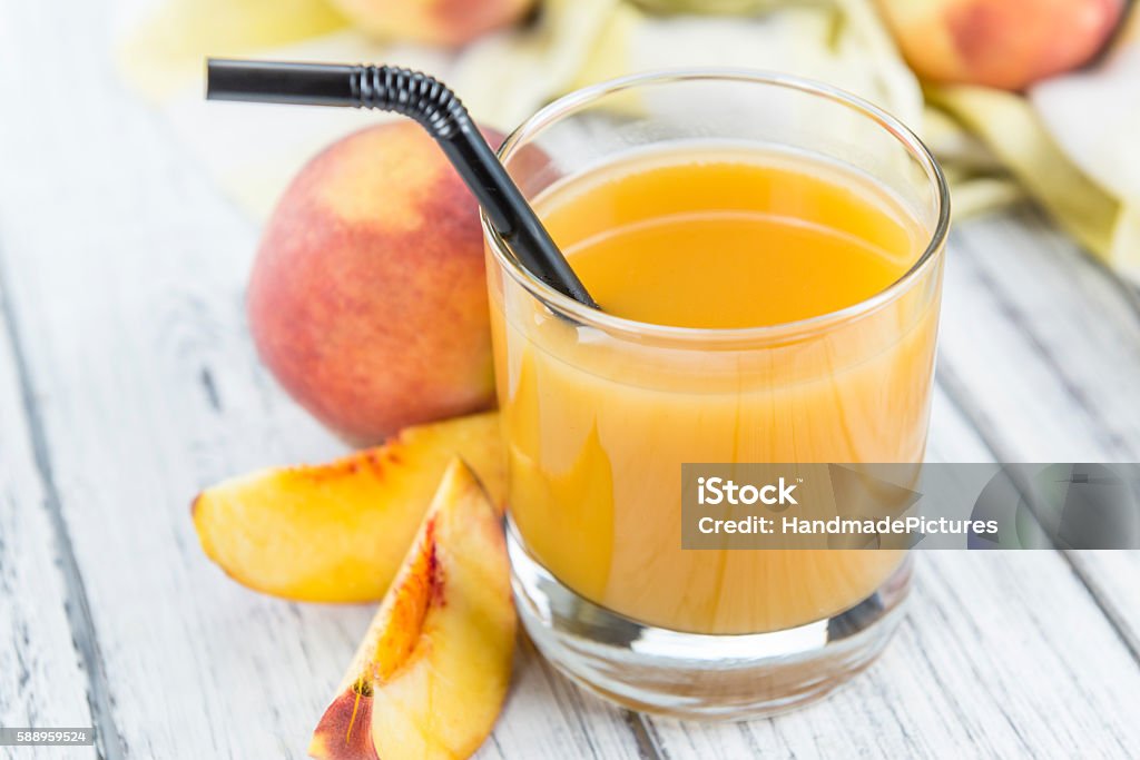 Peach juice Peach juice (detailed close-up shot) on an old wooden table Breakfast Stock Photo