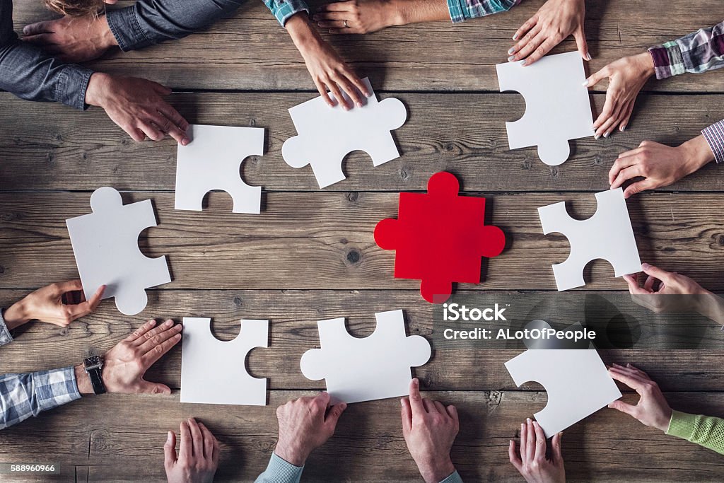 Teamwork meeting concept Hipster business successful teamwork concept, business group assembling jigsaw puzzle Jigsaw Puzzle Stock Photo