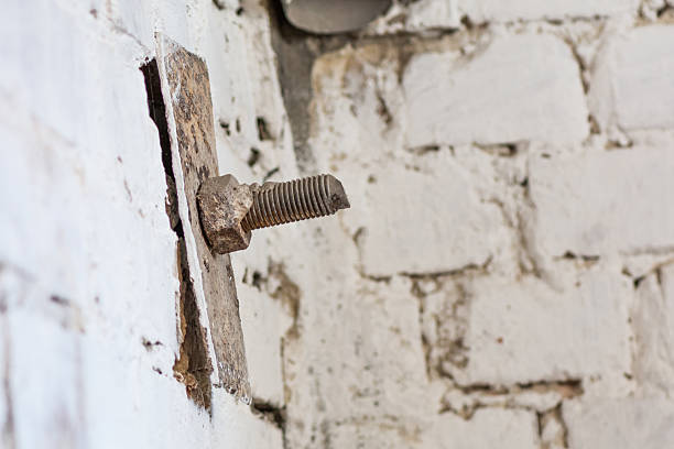 istock Old screw head in brick.Realistic image with old rusty screw. 588961520