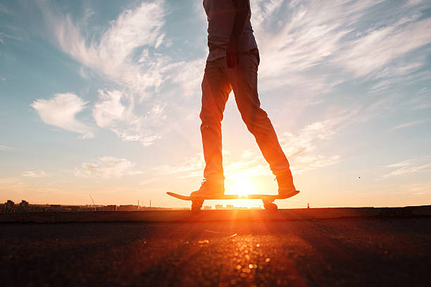 istock Young skaters training in the park in sunset. Birds. 588962310