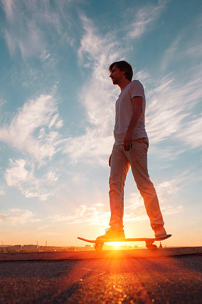 istock Young skaters training in the park in sunset. Birds. 588962464