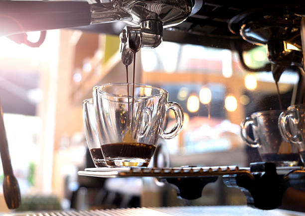 espresso pouring from coffee machine. stock photo