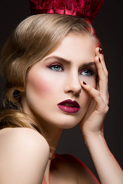 istock Beautiful girl with red makeup 588970848