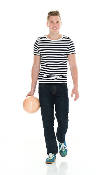 улыбающийся мужчина, держащий шар для боулинга и гуляя - bowling isolated sportsman vertical стоковые фото и изображения