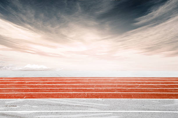 istock Low angle side shot of a running track, orange 588973298