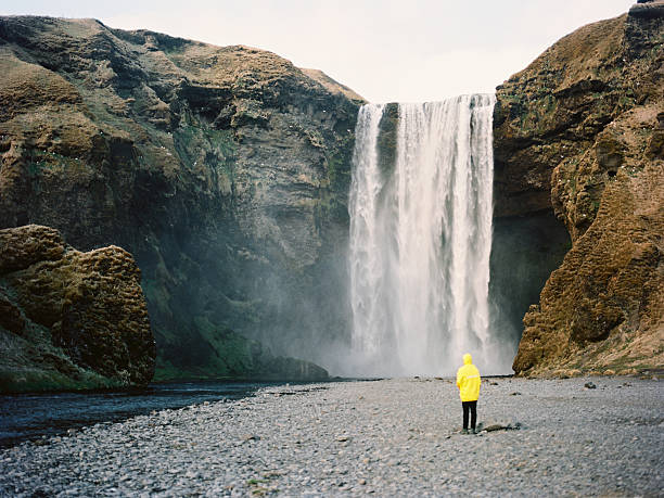 istock Man near the waterfall 588975138