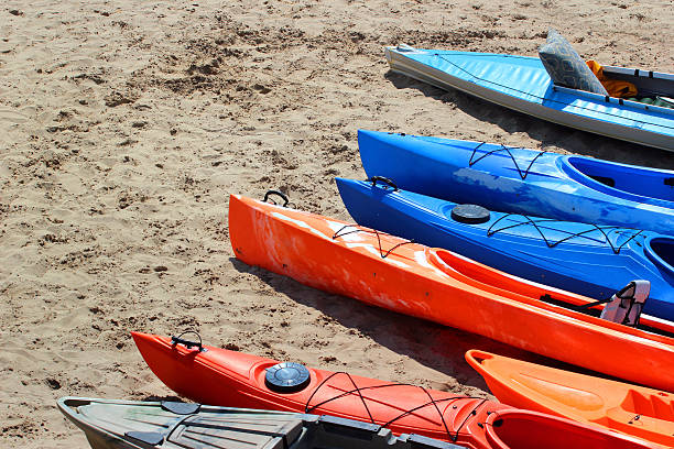 istock Colorful kayaks and canoes on sandy beach 588975420