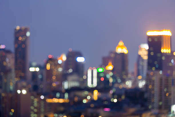 istock Blurred bokeh lights night view, city office building 588978270