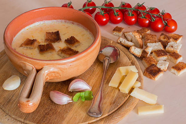 istock Cheese soup with crackers, cherry tomatoes and garlic 588978634