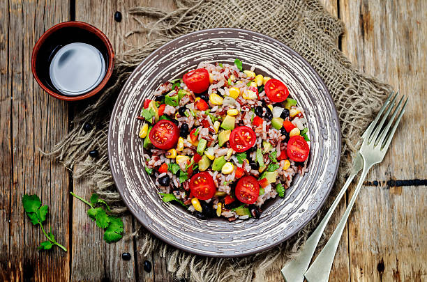 istock Red and white rice black beans corn avocado tomato salad 588978776
