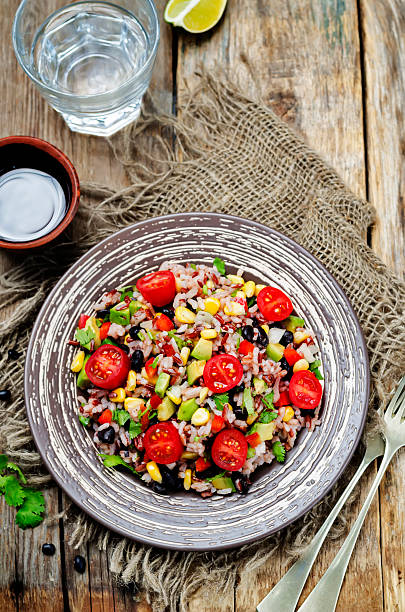 istock Red and white rice black beans corn avocado tomato salad 588978784