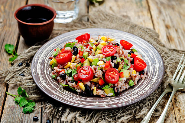 istock Red and white rice black beans corn avocado tomato salad 588978788