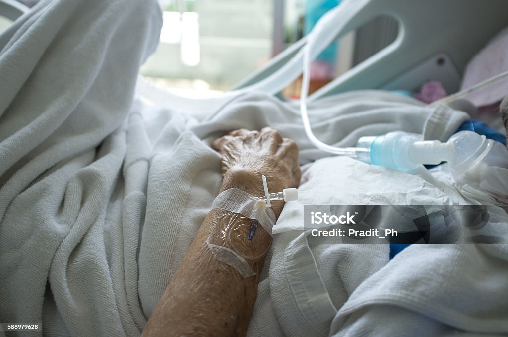 Elder patient's hand and blood test tube Death Stock Photo